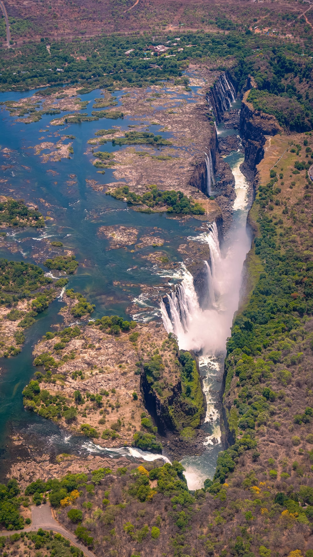 Victoria Falls from the air, the border running through the gorge below.